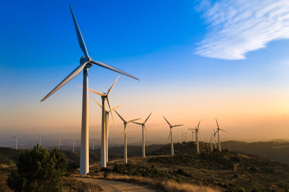 Wind turbines on the top of a hill.