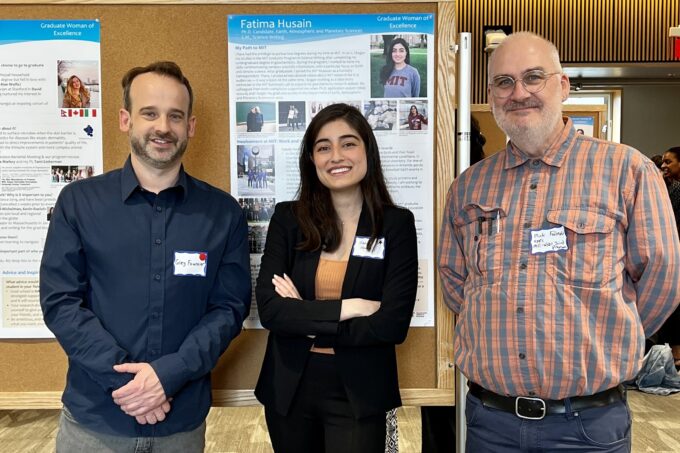 Greg Fournier, Fatima Husain, and Mick Follows stand together in front of a poster session.